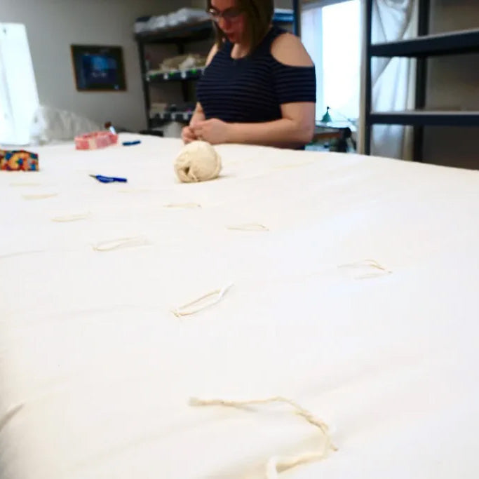 Hand knotting Comfort Temp Duvets in Michigan.