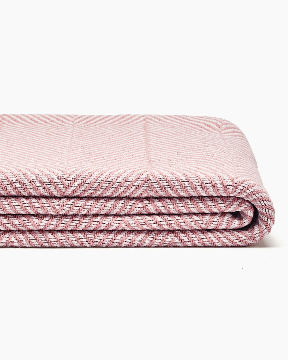 Stack of folded striped blankets in beige, yellow, and blue, displaying a wide herringbone pattern.